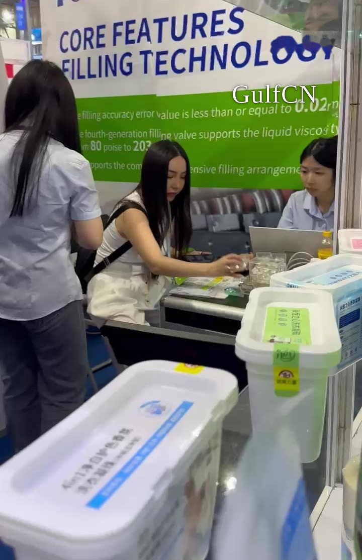 China trade-fair stand, team checking multi-chamber pod samples for a Dubai manufacturer